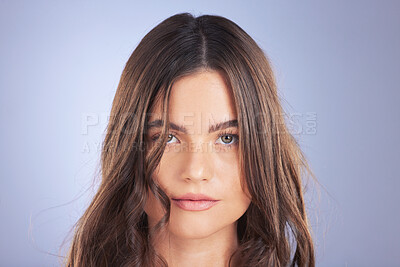 Buy stock photo Hair, woman and beauty face portrait in studio for skincare, growth and shine on blue background. Aesthetic female model serious with haircare, self care and cosmetic for salon or hairdresser results