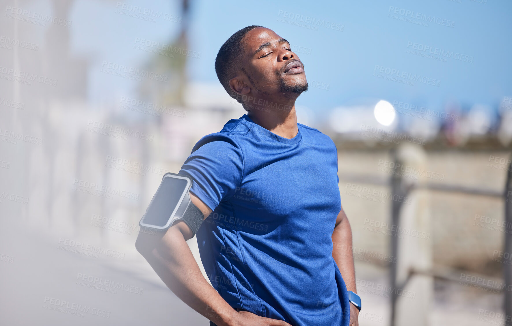 Buy stock photo Fitness, training and tired man runner outdoors for break from exercise, cardio or running on blurred background. Workout, stop and breathe by athletic male outside for marathon, run or sport routine