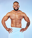 Exercise, shower towel and portrait of a black man with happiness from bodybuilder muscle. Cleaning, skincare and wellness after workout and fitness with isolated, studio and blue background