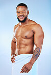 Towel, shower and training portrait of a black man with happiness from bodybuilder abs and arms. Cleaning, skincare and wellness after workout and exercise with isolated, studio and blue background