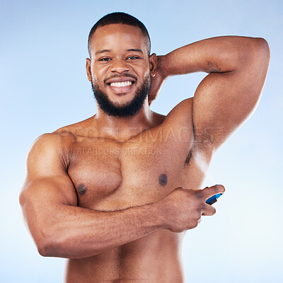 Buy stock photo Deodorant, portrait and black man with smile in studio for beauty, grooming and body hygiene on blue background. Skincare, health and male spraying aerosol, fragrance and scent product for underarm
