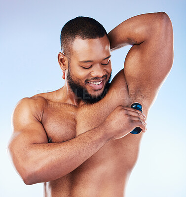 Buy stock photo Deodorant, skincare and black man for beauty, grooming and body hygiene on blue background. Wellness, health and male smile with antiperspirant, fragrance and scent product for underarm in studio