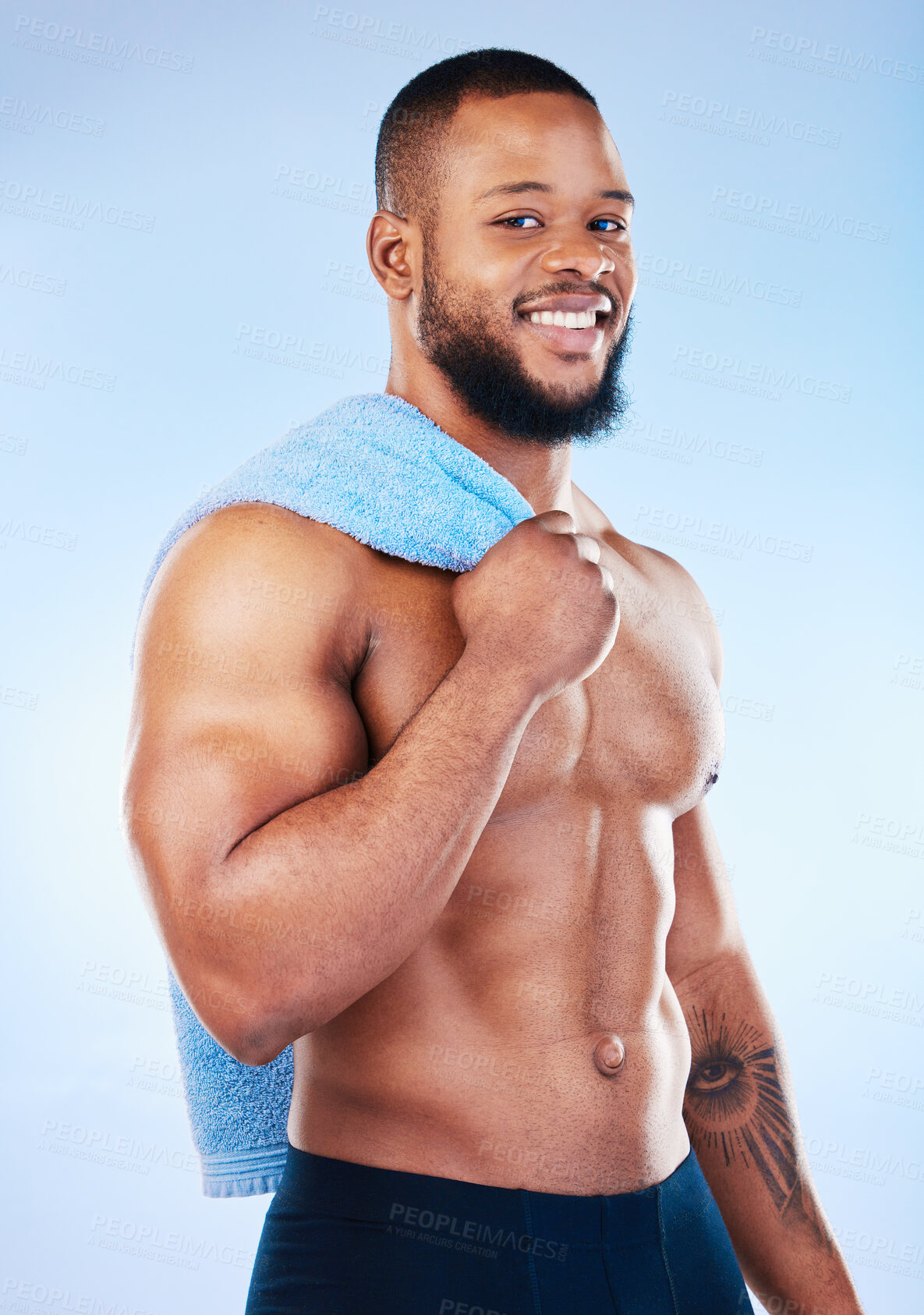 Buy stock photo Black man, portrait and body towel with a smile in studio for health, wellness and fitness. Face of healthy male aesthetic model with clean skin, strong muscle and happiness on a blue background