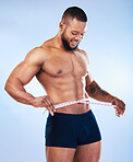 Black man, fitness and body, weightloss and measuring tape  with abs, health and active on blue background, Shirtless male bodybuilder, smile and exercise with diet, healthy and strong in underwear
