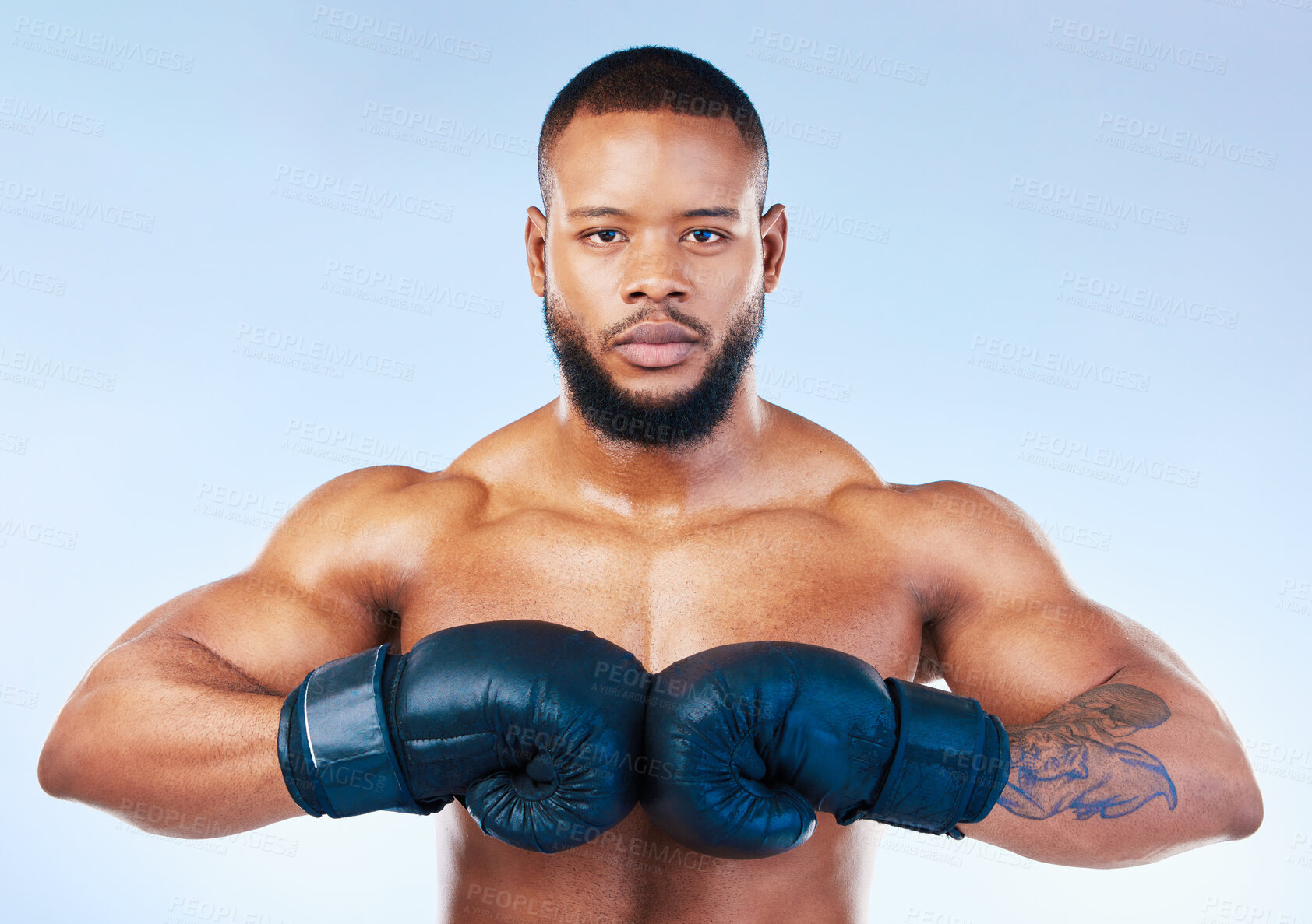 Buy stock photo Gloves, boxing and portrait of a serious black man isolated on a blue background in studio. Ready, fitness and an African boxer looking focused for training, cardio challenge or a fight on a backdrop