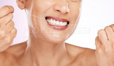 Face, smile and woman flossing teeth for cleaning, hygiene or tooth care in studio isolated on a purple background. Oral health, cosmetics and happy mature female model with dental floss for wellness