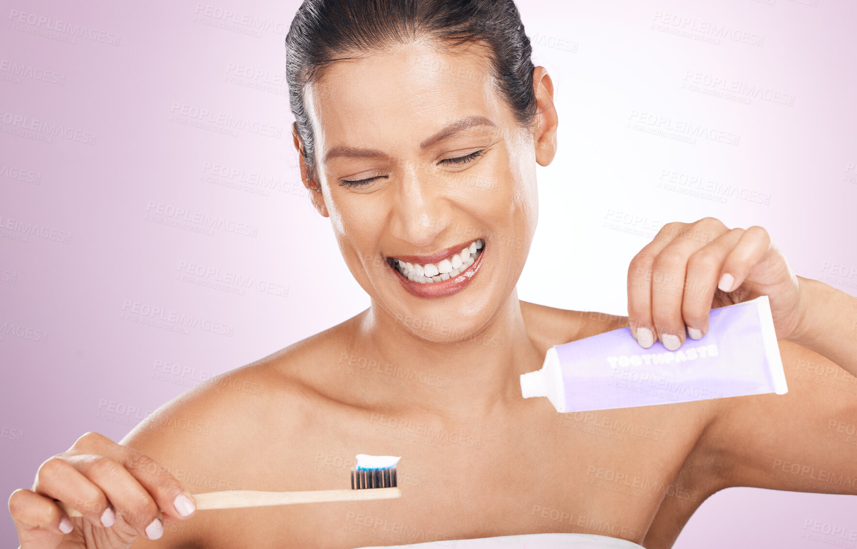 Buy stock photo Smile, woman and bamboo toothbrush and toothpaste in studio isolated on a purple background. Eco friendly, cleaning and happy mature female brushing teeth with natural wooden brush for dental hygiene