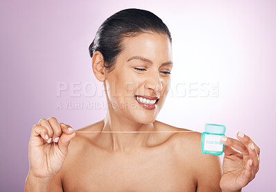 Buy stock photo Face, smile and woman with dental floss for cleaning, hygiene or tooth care in studio isolated on a purple background. Oral health, cosmetics and happy mature female model flossing teeth for wellness