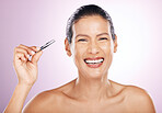 Beauty, portrait and woman with tweezers in studio for mature facial hair removal routine. Self care, grooming and female model plucking her eyebrows for face epilation treatment by purple background