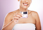 Hands, cream jar and woman smile in studio isolated on purple background. Face skincare, dermatology cosmetics and happy female holding lotion container, creme or moisturizer product for skin health.