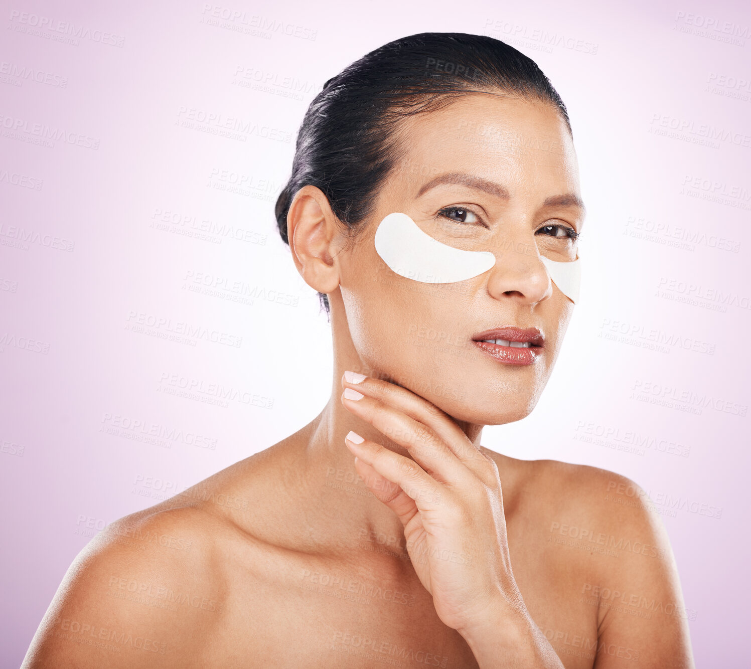 Buy stock photo Face, skincare and woman with eye patches in studio isolated on a purple background. Portrait, dermatology and serious or mature female model with facial mask or collagen cosmetics for healthy skin.