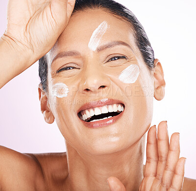 Face, cream and skincare of woman laughing in studio isolated on a purple background. Mature, portrait and funny female model with dermatology lotion, creme and moisturizer cosmetics for healthy skin