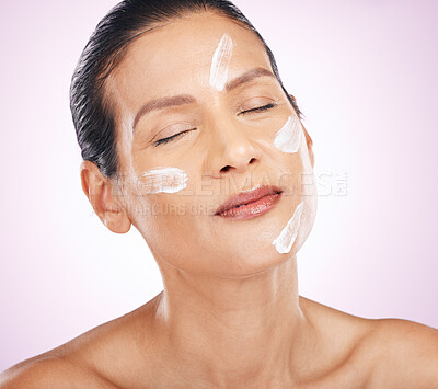 Buy stock photo Face, cream and skincare of woman with eyes closed in studio isolated on a purple background. Mature, cosmetics and serious female model with dermatology lotion, creme or moisturizer for healthy skin