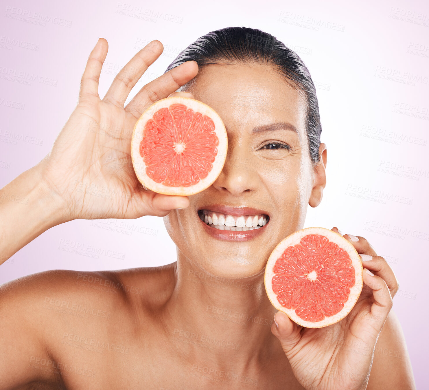 Buy stock photo Face smile, grapefruit and skincare of woman in studio isolated on a purple background. Natural cosmetics, portrait and happy mature female model with fruit for vitamin c, nutrition or healthy diet.