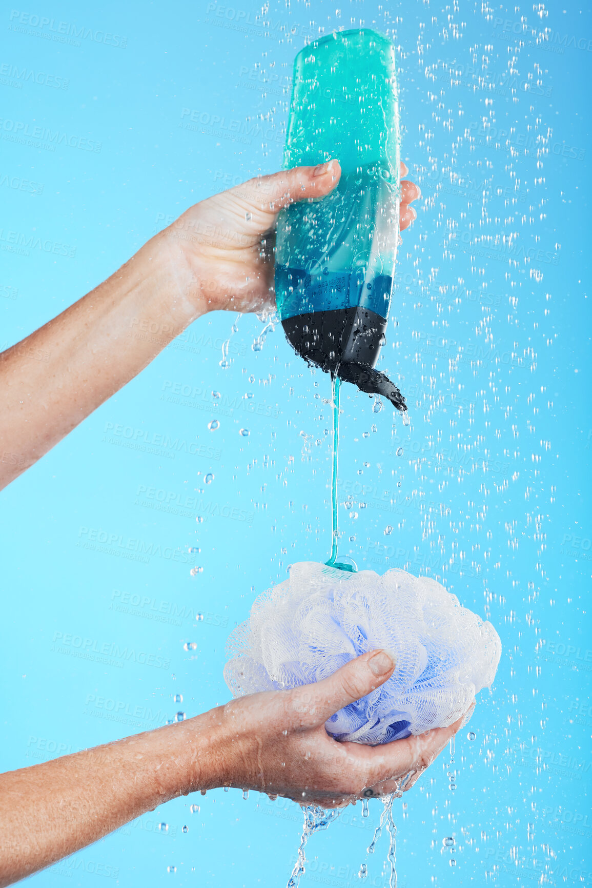 Buy stock photo Skincare, product and hands with loofah and shower gel of person washing isolated in a studio blue background. Self care, beauty and person or model using soap and sponge for morning routine