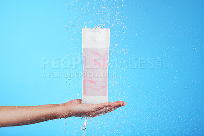 Buy stock photo Shampoo, showing and hand with a bottle in the shower isolated on a blue background in studio. Cleaning, hygiene and person advertising a product for grooming, sanitary care and treatment with mockup