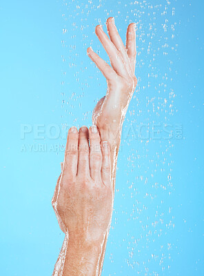 Buy stock photo Woman, hands and water drops, hygiene and handwashing, skincare and moisture on blue background. Natural, sustainability and wellness with eco friendly dermatology, shower and cleaning for health