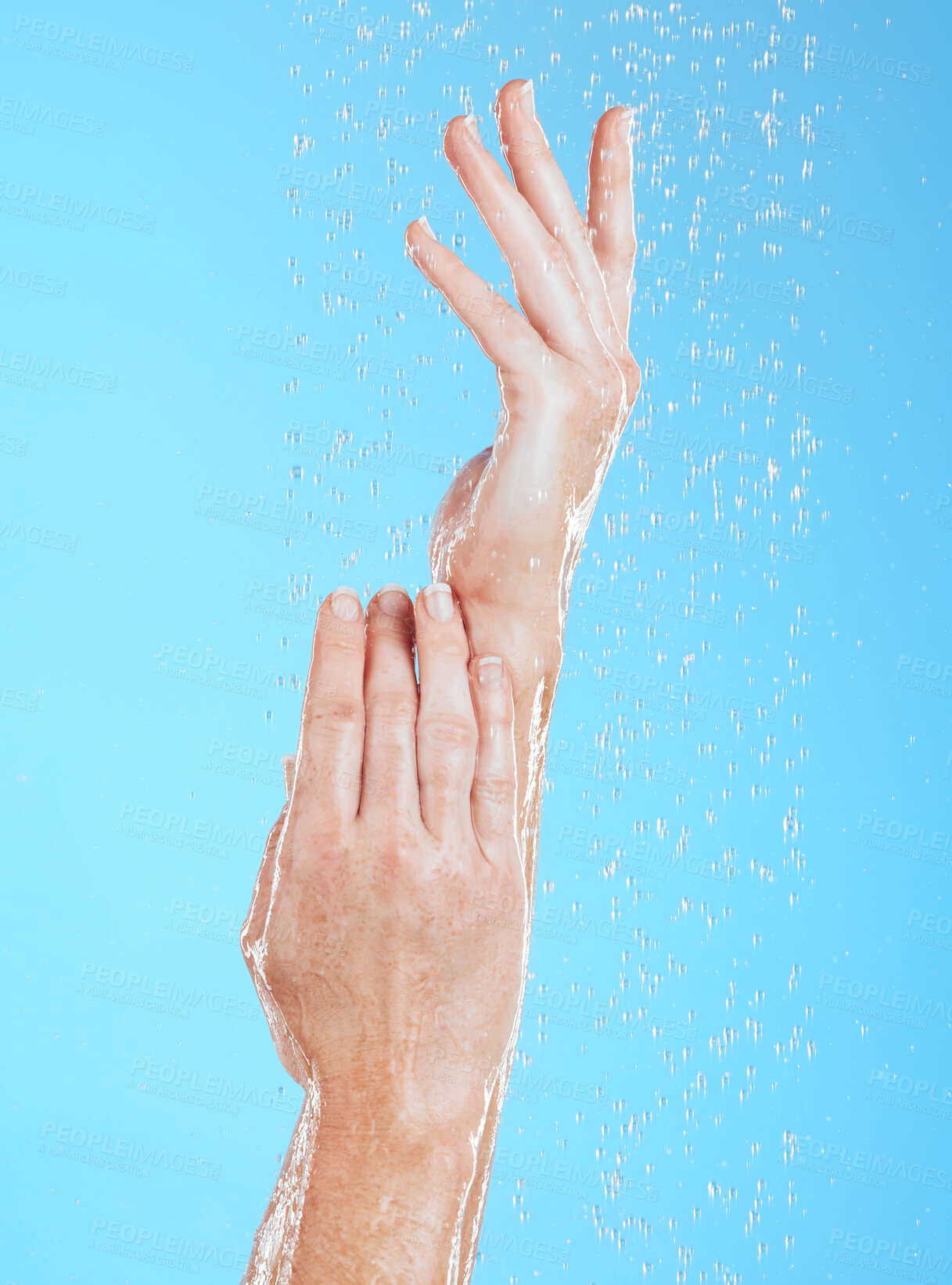 Buy stock photo Woman, hands and water drops, hygiene and handwashing, skincare and moisture on blue background. Natural, sustainability and wellness with eco friendly dermatology, shower and cleaning for health