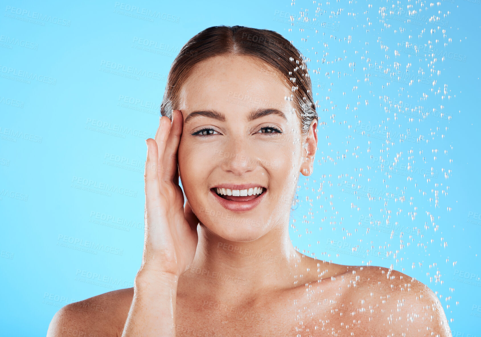 Buy stock photo Shower, water and portrait of happy woman in a studio face from cleaning and skincare. Wellness, splash and beauty routine of female model excited from dermatology and self care with blue background