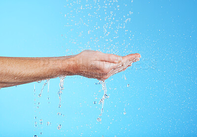 Buy stock photo Woman hands, cleaning and water in a studio for skincare, safety and healthcare from virus. Isolated, blue background and hand wash for hygiene wellness and sanitary protection with liquid stream 