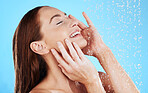 Shower, water and smile of woman in studio, blue background and cleaning for hygiene. Happy female model washing with wet drops for beauty, skincare and grooming for self care, wellness and routine 