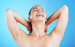 Water, shower and woman washing in studio for skincare, wellness and clean body for self care. Face of female aesthetic model, splash or drops for cleaning, hygiene and cosmetics on blue background