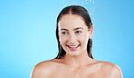 Water, shower and happy woman washing in studio for skincare, wellness and clean body for self care. Face of female model, splash or drop for cleaning, hygiene and cosmetics on blue background mockup