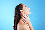 Water, shower and washing profile of woman in studio for skincare, wellness and clean body for self care. Female aesthetic model, splash or drop for cleaning, hygiene and cosmetics on blue background