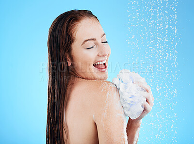 Buy stock photo Woman in shower, laughing and happy with soap, hygiene and water drops with skincare on blue background. Washing, grooming and cosmetic care, female cleaning body with foam and mockup in studio