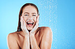 Woman in shower, happy in portrait with hygiene and water drops, soap and clean with excited face on blue background. Facial, hydration and skincare with female cleaning body, foam and mockup space