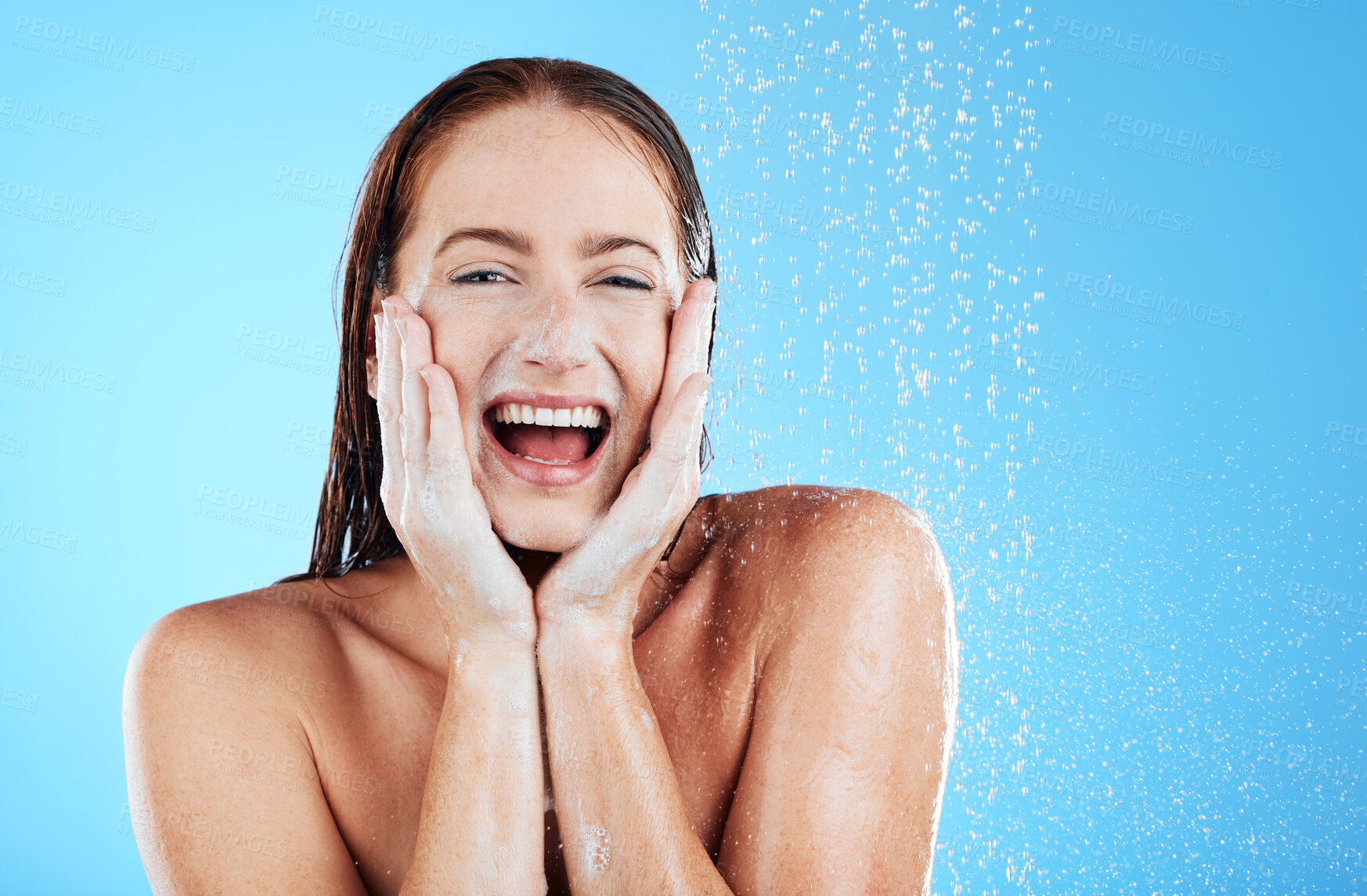 Buy stock photo Woman in shower, happy in portrait with hygiene and water drops, soap and clean with excited face on blue background. Facial, hydration and skincare with female cleaning body, foam and mockup space