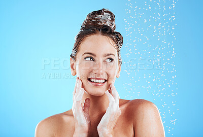 Buy stock photo Haircare, shower and woman in a studio with a beauty, wellness and healthy self care routine. Happy, smile and female model washing her hair with shampoo and water while isolated by a blue background