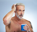 Hair care, grooming and mature man with gel isolated on a blue background in studio. Beauty, clean and a senior man with a product for styling, hairstyle and applying balm for a hairdo on a backdrop