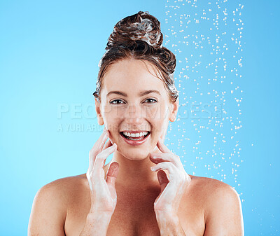 Buy stock photo Hair care, shower and portrait of a female in a studio with a beauty, wellness and self care routine. Happy, smile and woman model washing her hair with shampoo and water isolated by blue background.