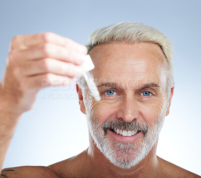Buy stock photo Old man, portrait and smile, face with serum for skincare, beauty and grooming with facial oil on studio background. Closeup of dropper, anti aging cosmetic care with happy senior male and hygiene