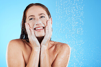 Buy stock photo Shower, water and face of happy woman with soap in studio, blue background and skincare cleaning. Female model washing facial with foam, wet drops and beauty of self care, glow and smile on backdrop