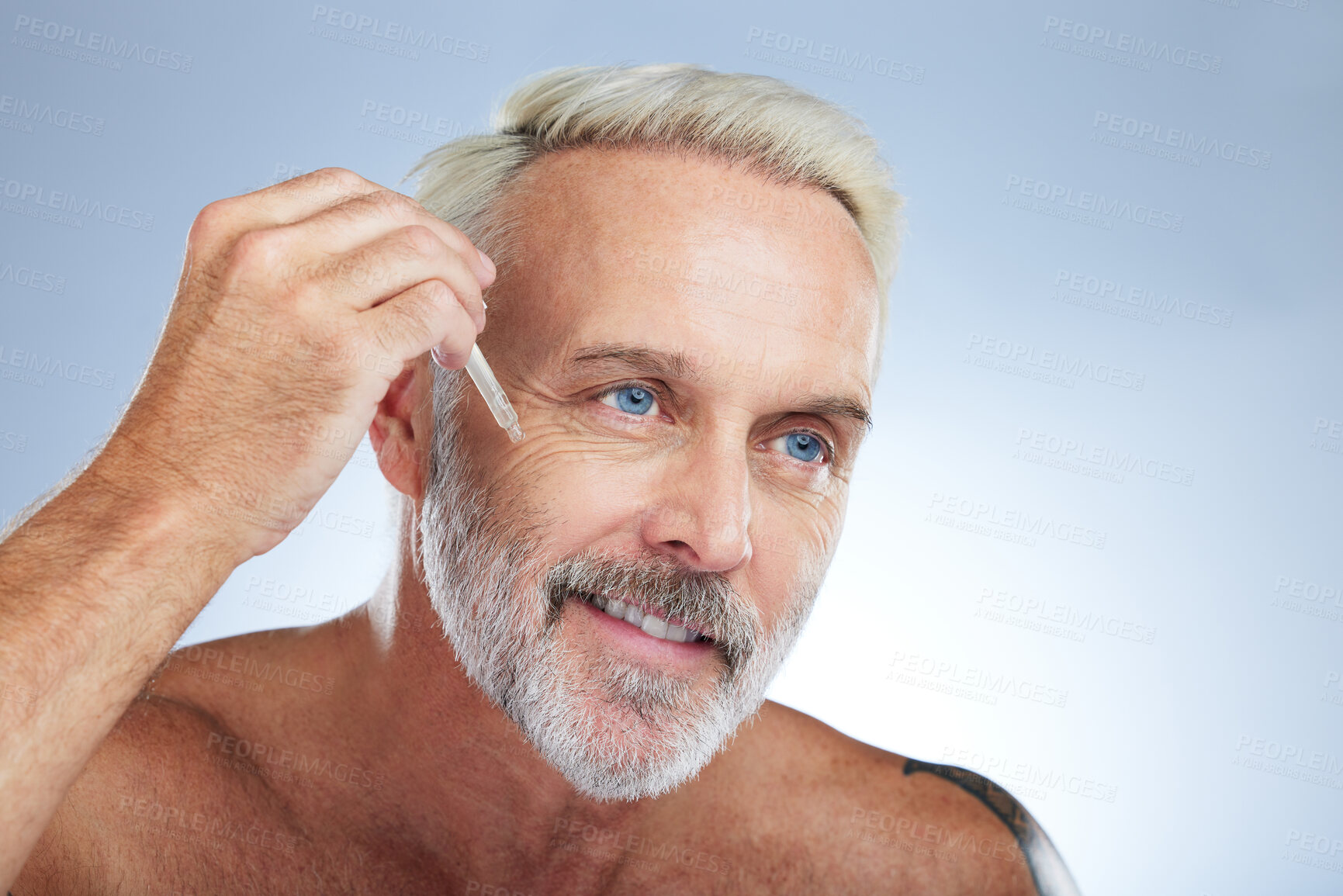 Buy stock photo Old man, smile and facial oil for skincare, beauty and grooming, apply serum on face against studio background. Dropper, anti aging cosmetic care with senior male and mockup, hygiene with dermatology