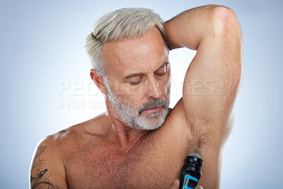 Buy stock photo Skincare, deodorant and senior man for wellness, body hygiene and cleaning products on blue background. Beauty, grooming mockup and elderly male with antiperspirant, fragrance and underarm in studio