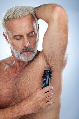 Buy stock photo Skincare, deodorant and senior man for armpit, body hygiene and beauty products on blue background. Wellness, grooming mockup and elderly male with antiperspirant, fragrance and underarm in studio
