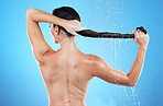 Back of woman, shower and hair care in studio, blue background and hygiene routine. Female model cleaning head with water for scalp, beauty and shampoo cosmetics of skincare, wellness and grooming