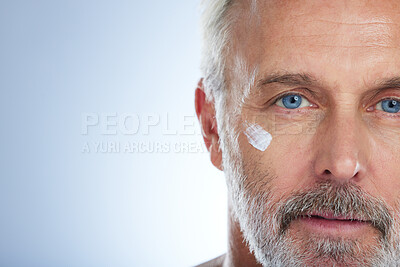Buy stock photo Senior man, cream and portrait, face with skincare and beauty, hygiene and grooming on studio background. Lotion, moisturizer and dermatology mockup, anti aging cosmetic care and serious male closeup