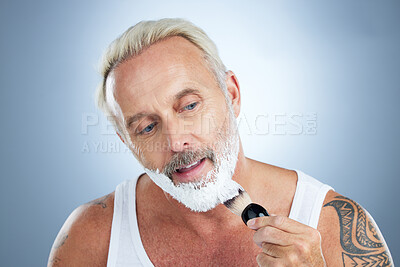 Buy stock photo Mature man, beard and shaving cream for skincare, grooming or hair removal against studio background. Senior male face applying shave creme or foam product with brush for haircare or facial treatment