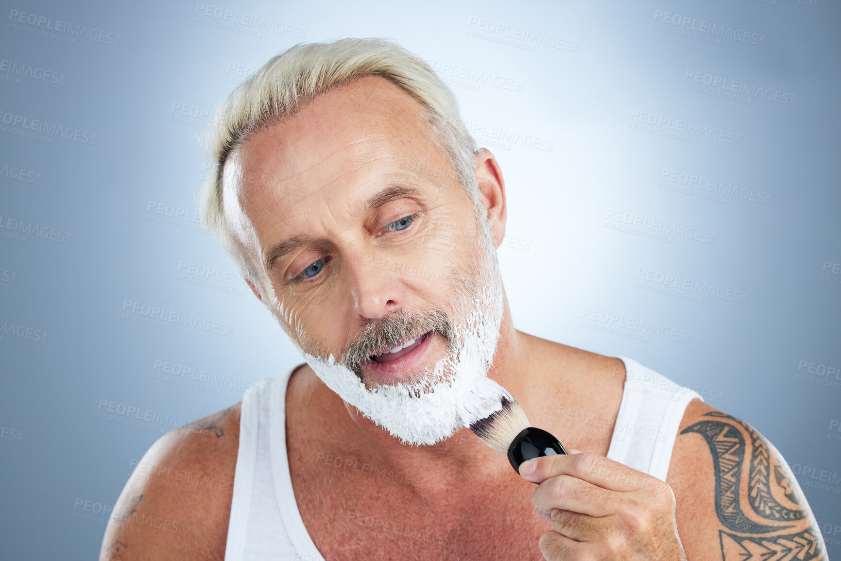 Buy stock photo Mature man, beard and shaving cream for skincare, grooming or hair removal against studio background. Senior male face applying shave creme or foam product with brush for haircare or facial treatment