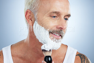 Buy stock photo Senior man, beard and shaving cream for skincare, grooming or hair removal against studio background. Mature male face applying shave creme or foam product with brush for haircare or facial treatment