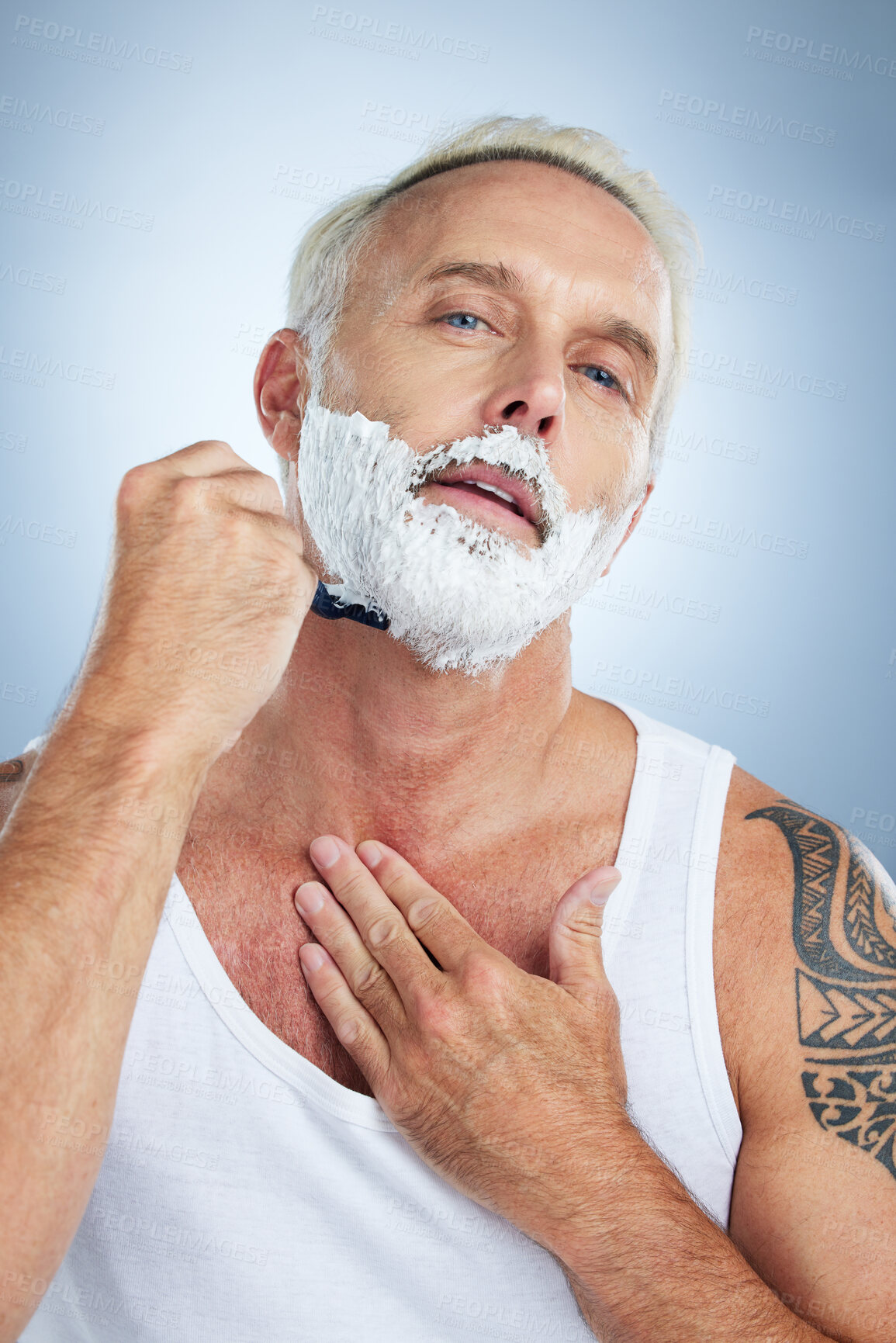 Buy stock photo Senior man, razor and shaving beard with cream for grooming, skincare or hair removal against a studio background. Portrait of mature male with shaver, creme or foam for hygiene or facial treatment