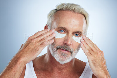 Buy stock photo Beauty mask, eyes and portrait of old man in studio for wellness, facial treatment and anti aging cosmetics. Skincare, dermatology and face of senior male with patches for detox, grooming and health