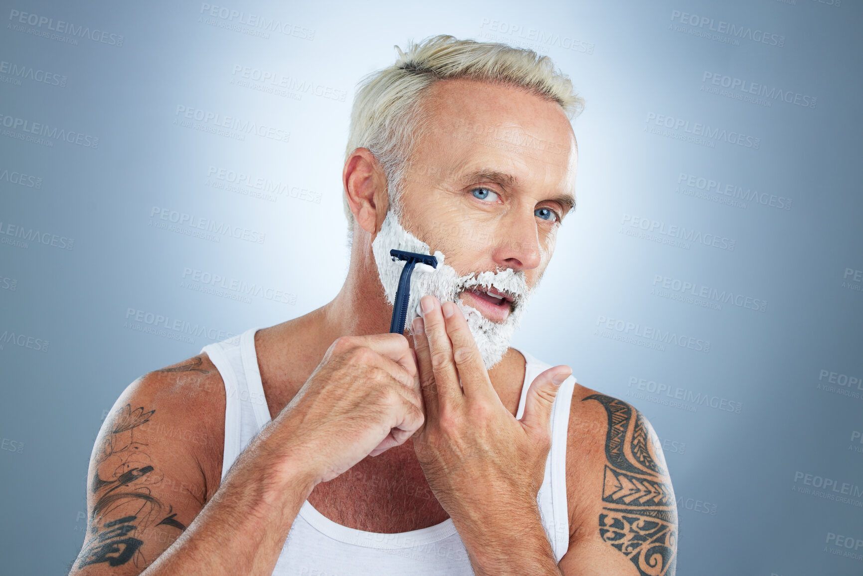 Buy stock photo Senior man, razor and shaving beard with cream for grooming, skincare or hair removal against a studio background. Portrait of mature male with shaver, creme or foam for hygiene or facial treatment