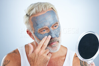 Buy stock photo Man, mirror and clay mask for face skincare, wellness and organic cleaning with smile by studio background. Elderly male, hand and natural charcoal product for facial cosmetics for dermatology detox