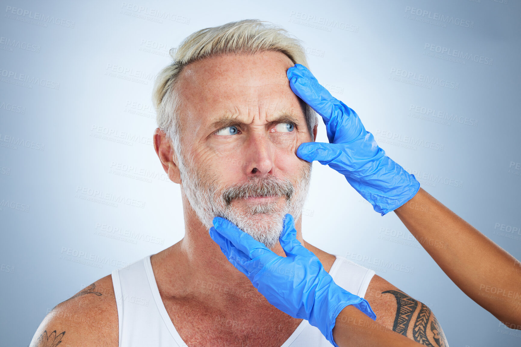 Buy stock photo Needle, confused face and senior man in a studio doing plastic surgery and cosmetic skincare. Dermatology gloves, wrinkles and anti aging treatment of a mature model prepare for medical procedure 