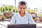 Woman, laptop and headphones, student and education with smile, study and online course, elearning and university. Female at outdoor cafe, writing thesis and listen to music with research for paper